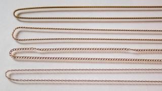 Four 18k gold chains side by side: round snake, rope, open curb and trace anchor chain
